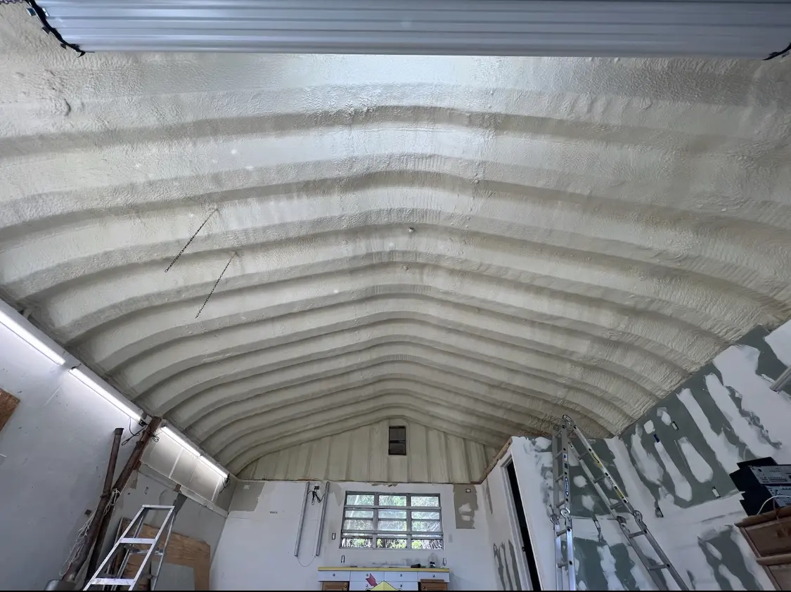 Spray polyurethane foam applied to the underside of a metal roof deck in Gilford